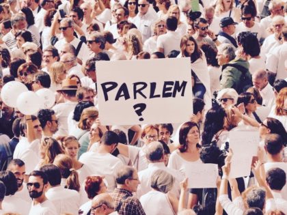 A woman holds up a sign that redads  shall we talk   in Catalan during a demonstration in a square in Barcelona