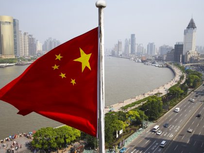 Chinese flag overlooking cityscape, Shanghai, China