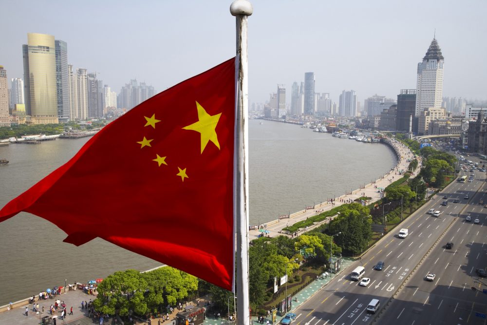 Chinese flag overlooking cityscape, Shanghai, China