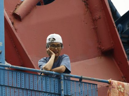 Labour activist Kim Jin-suk looks at her supporters from the 35-metre-high crane No. 85 at Busan shipyard of Hanjin Heavy Industries and Construction (HHIC) in Busan