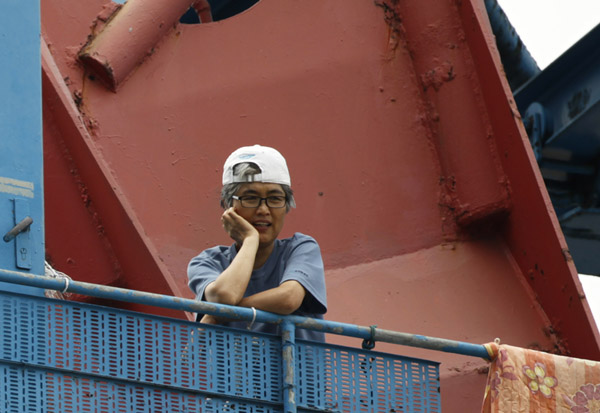Labour activist Kim Jin-suk looks at her supporters from the 35-metre-high crane No. 85 at Busan shipyard of Hanjin Heavy Industries and Construction (HHIC) in Busan