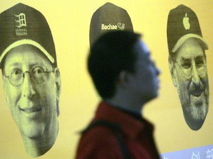 A Chinese jobseeker walks pass a poster