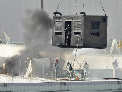 Riot police in a container try to climb