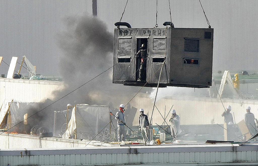 Riot police in a container try to climb