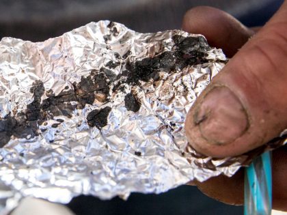 Roger Boyd, 35, holds a piece of foil containing Fentanyl while spending time on McAllister Street in the Tenderloin district of San Francisco, Calif. Friday, June 21, 2019.