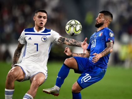 Lorenzo Insigne (R) of Italy competes for the ball with