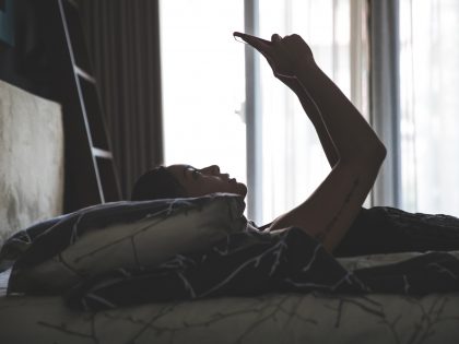 Chinese asian young woman relaxing in the bedroom