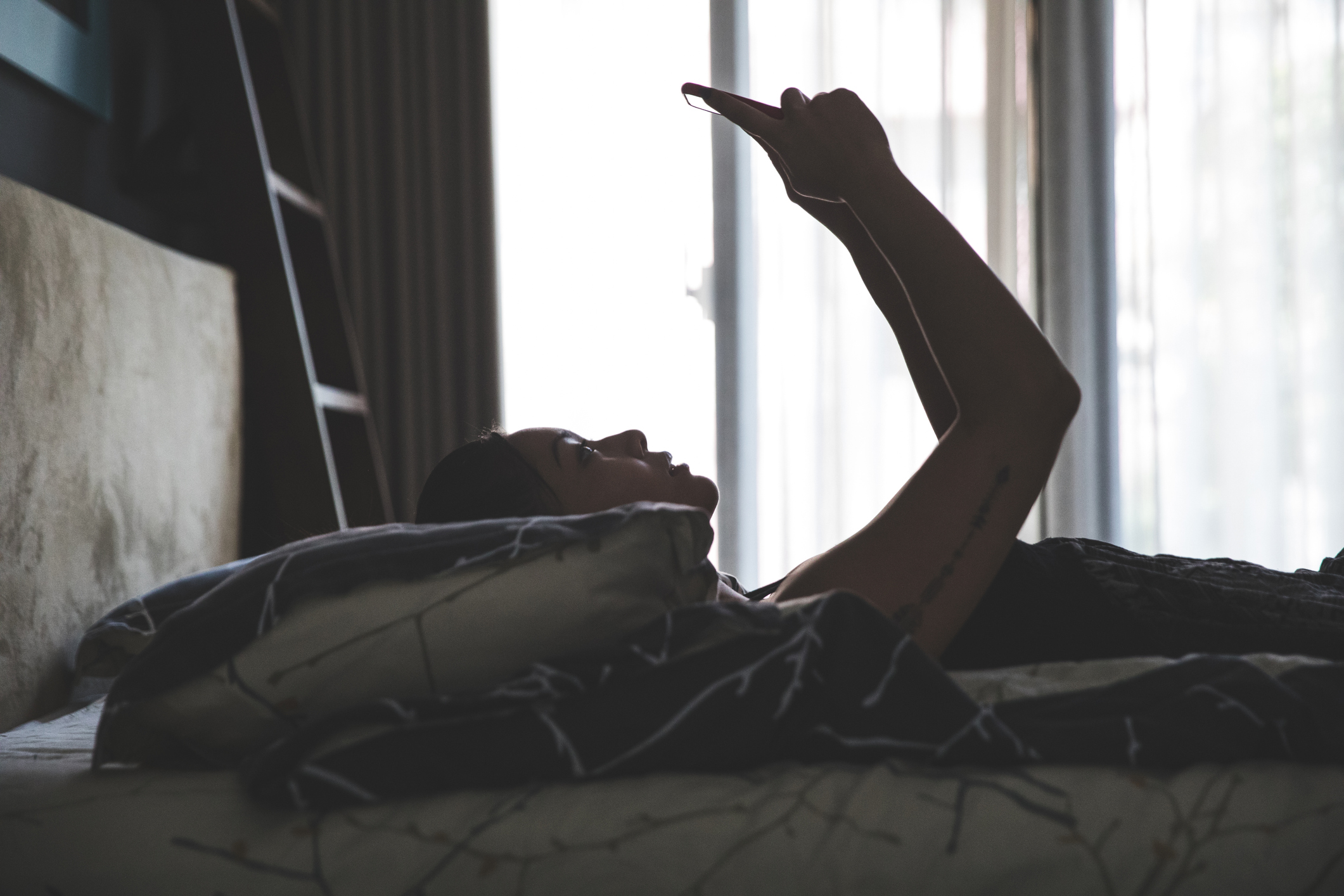 Chinese asian young woman relaxing in the bedroom