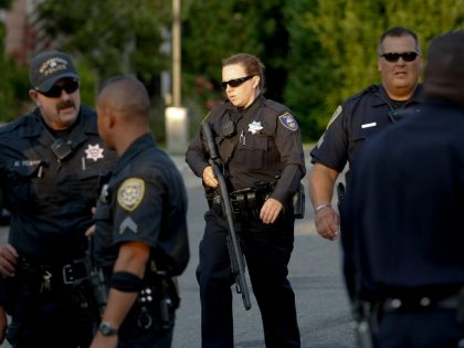 Richmond Police officers converge on a home near the corner of 2nd St. and Nevin St. searching for a possible suspect involved in a  shooting at the Richmond San Rafael Bridge toll plaza that left two people dead.