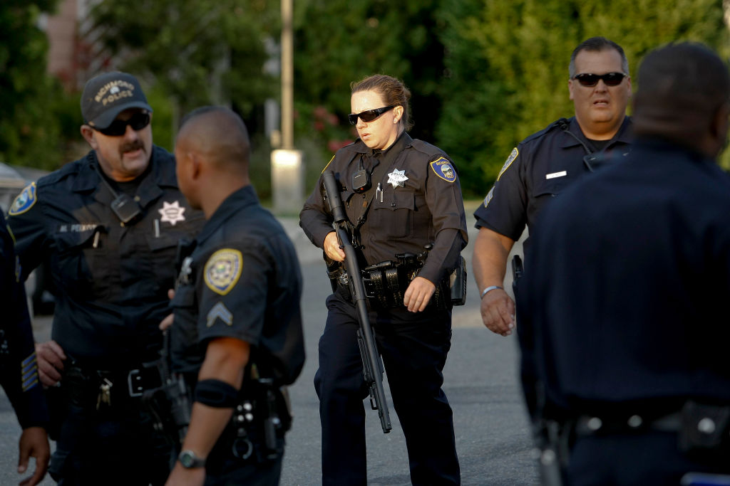 Richmond Police officers converge on a home near the corner of 2nd St. and Nevin St. searching for a possible suspect involved in a  shooting at the Richmond San Rafael Bridge toll plaza that left two people dead.
