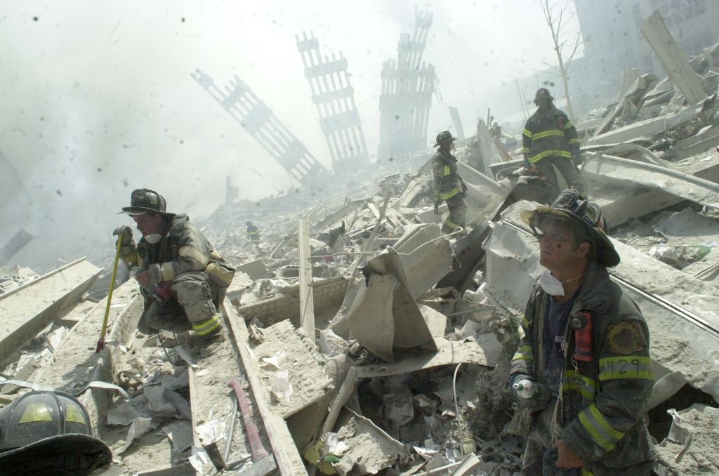 Firefighters search through the rubble of the World Trade Ce