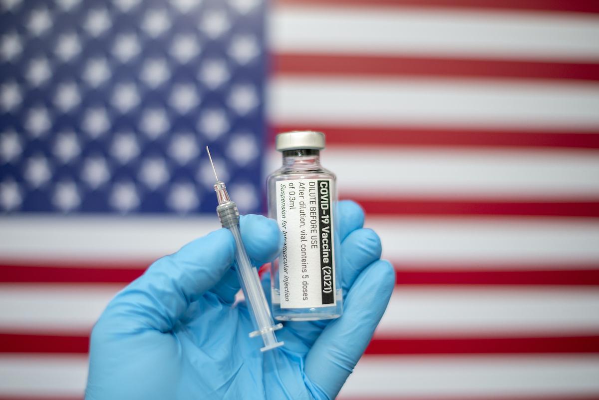 Covid-19 vaccine with syringe and American flag image in the background, Coronavirus SARS-CoV-2, vaccination