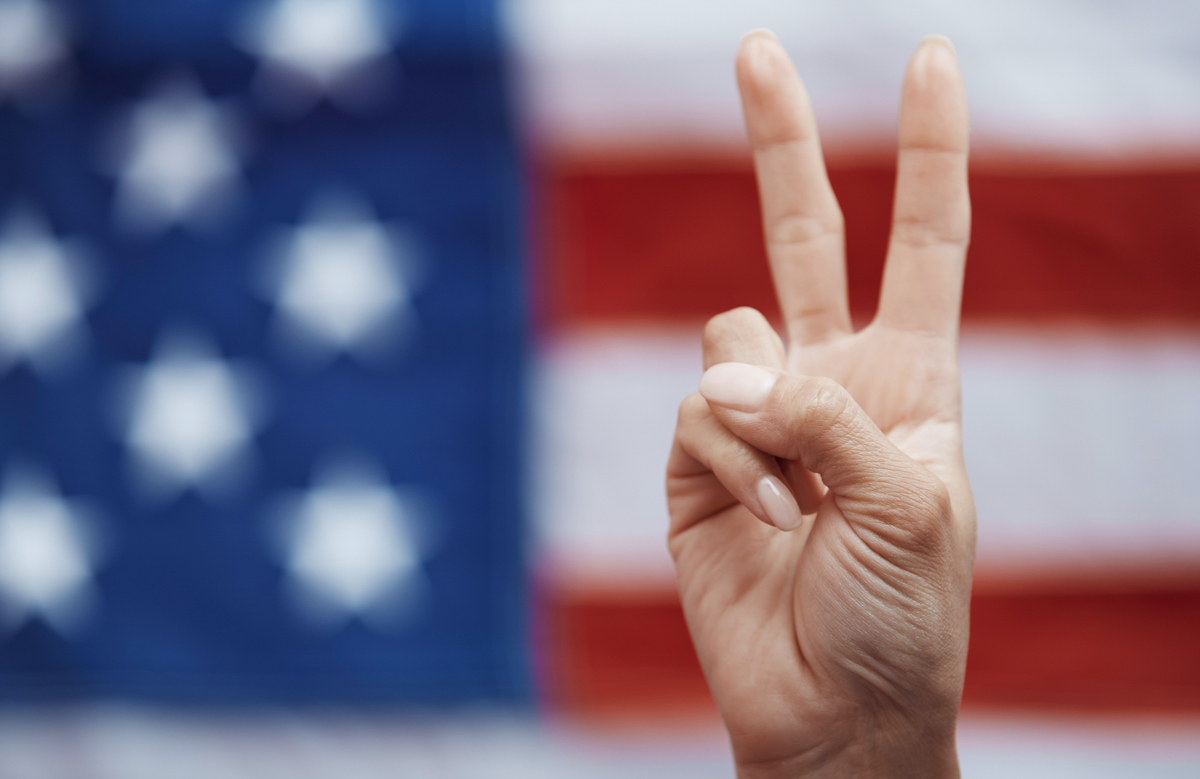 Human making Peace symbol on American flag background