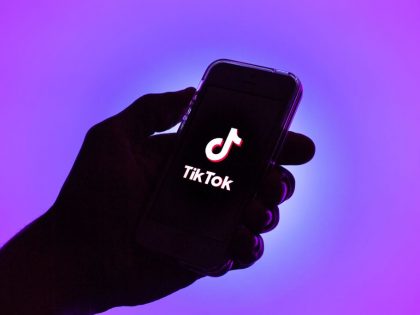In this photo illustration, a Tik Tok logo seen displayed on