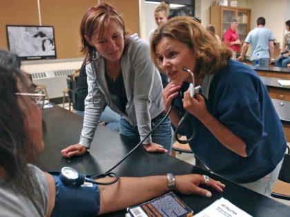 JOEY MCLEISTER ¬¨‚Ä¢ jmcleister@startribune.com Duluth,Mn.,-Tues.,June 27, 2006--(Left to right) Bob Miller,student support services assistant in the Center of American Indian and Minority Health, has his blood pressure taken by Jody Barry and Suzanne Anic