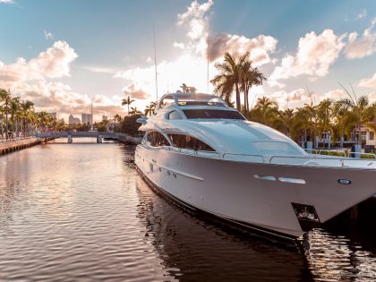 Front view of the sun coming down at sunset in Fort Lauderdale canals. Luxury yachts in Las Olas Boulevard, Florida, USA