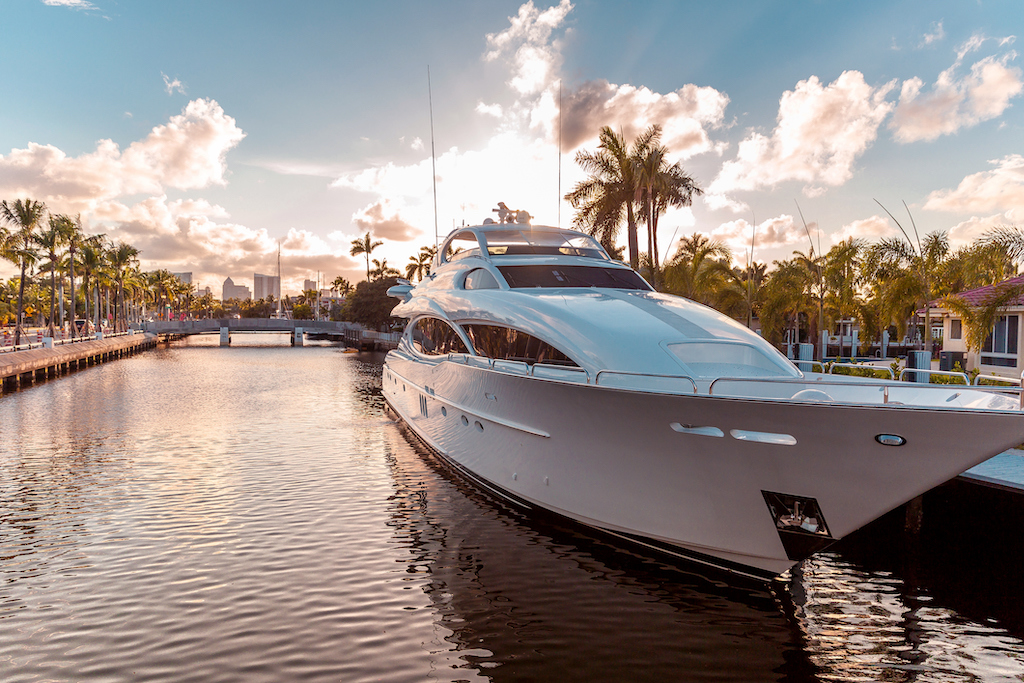 Front view of the sun coming down at sunset in Fort Lauderdale canals. Luxury yachts in Las Olas Boulevard, Florida, USA
