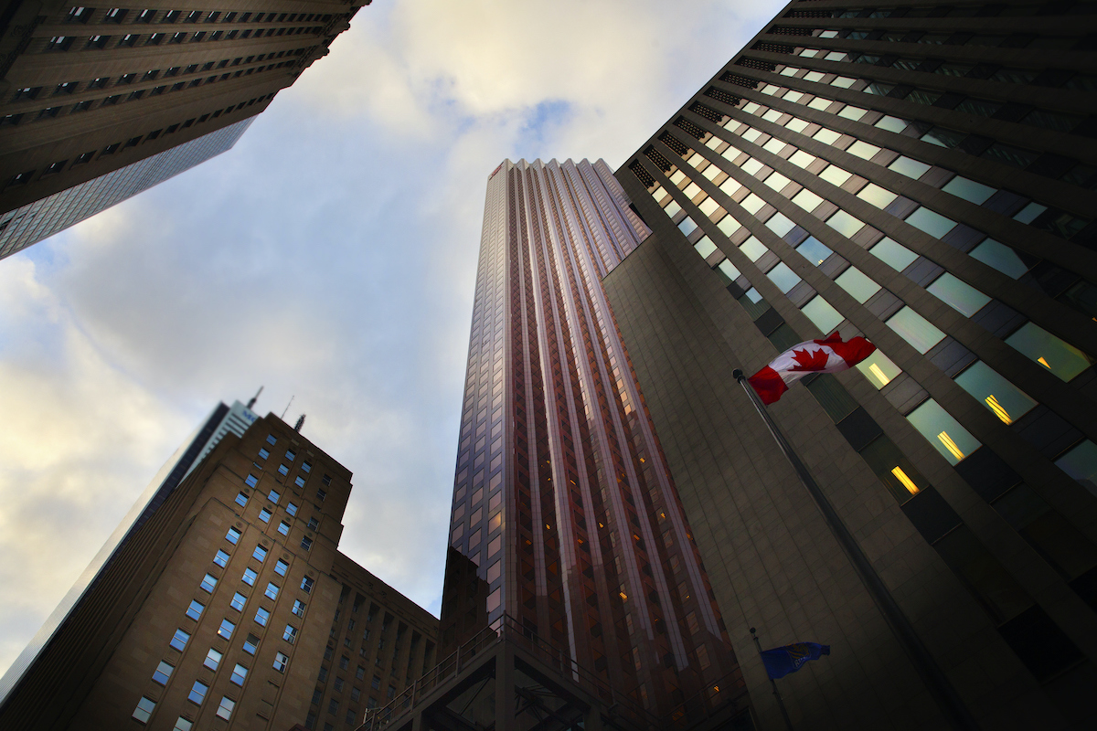 The Canadian flag and downtown office buildings