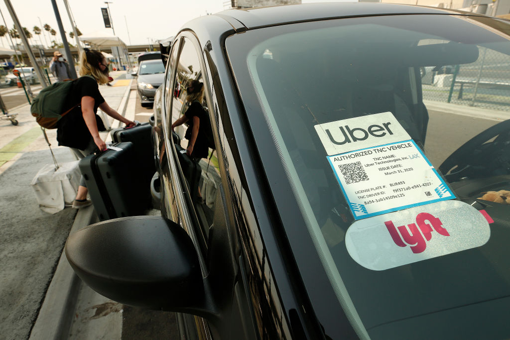 Uber and Lyft drivers with the Mobile Workers Alliance held a moving rally as part of a statewide day of action to demand that both ride-hailing companies follow California law and grant drivers basic employee rights and to denounce the corporations effort