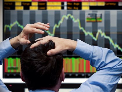 Trader watching stocks crash on screen
