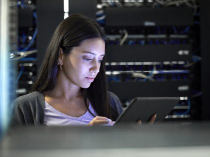 Female engineer working in server room