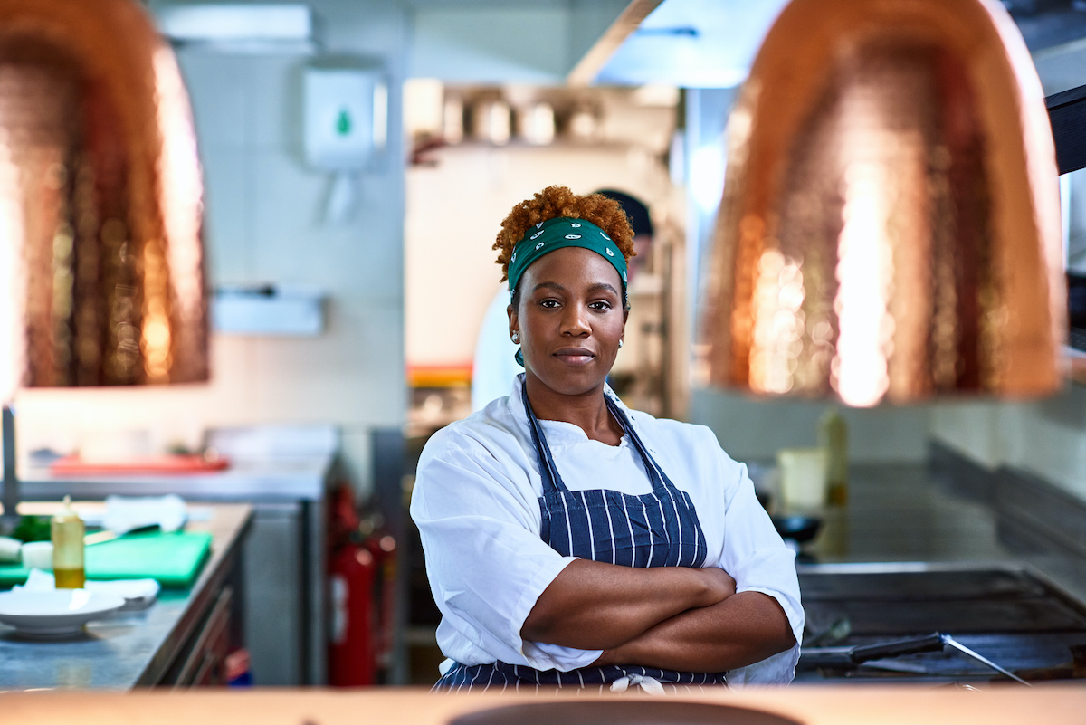 Portrait of black female chef in commercial kitchen