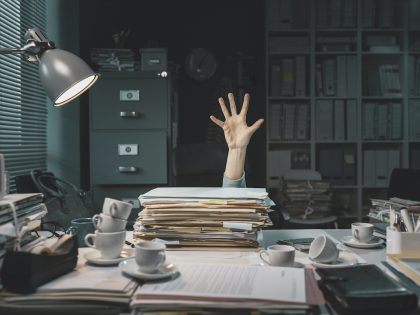 Office worker overwhelmed with paperwork