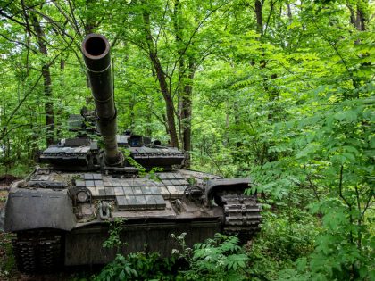 A Ukrainian military tank hidden in an undisclosed defense