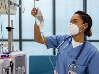 Nurse at the hospital putting an IV Drip on a patient