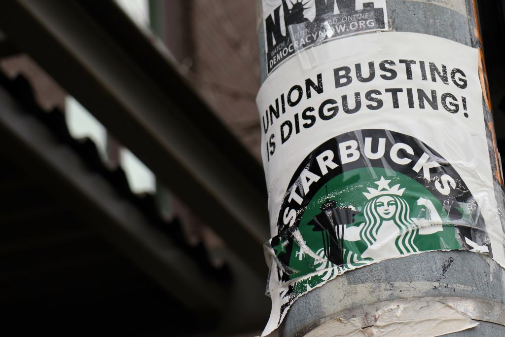 A pro-union poster is seen on a lamp pole outside Starbucks