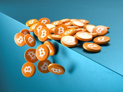 Crash of Bitcoin concept: Coin like cylinders with the bitcoin logo falling over the edge of a cube.