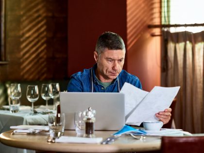 Restaurant owner reading documents during pandemic