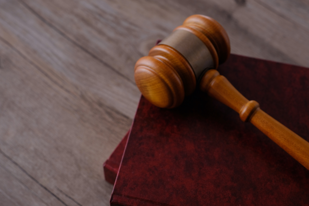 Judge gavel with books on wooden table