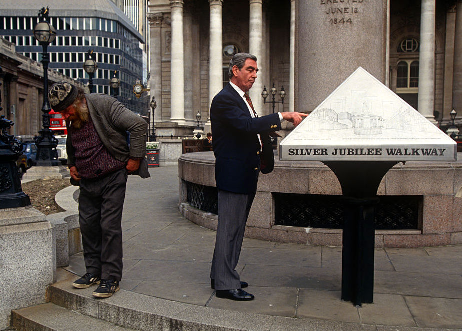 UK - London - Homeless man and businessman