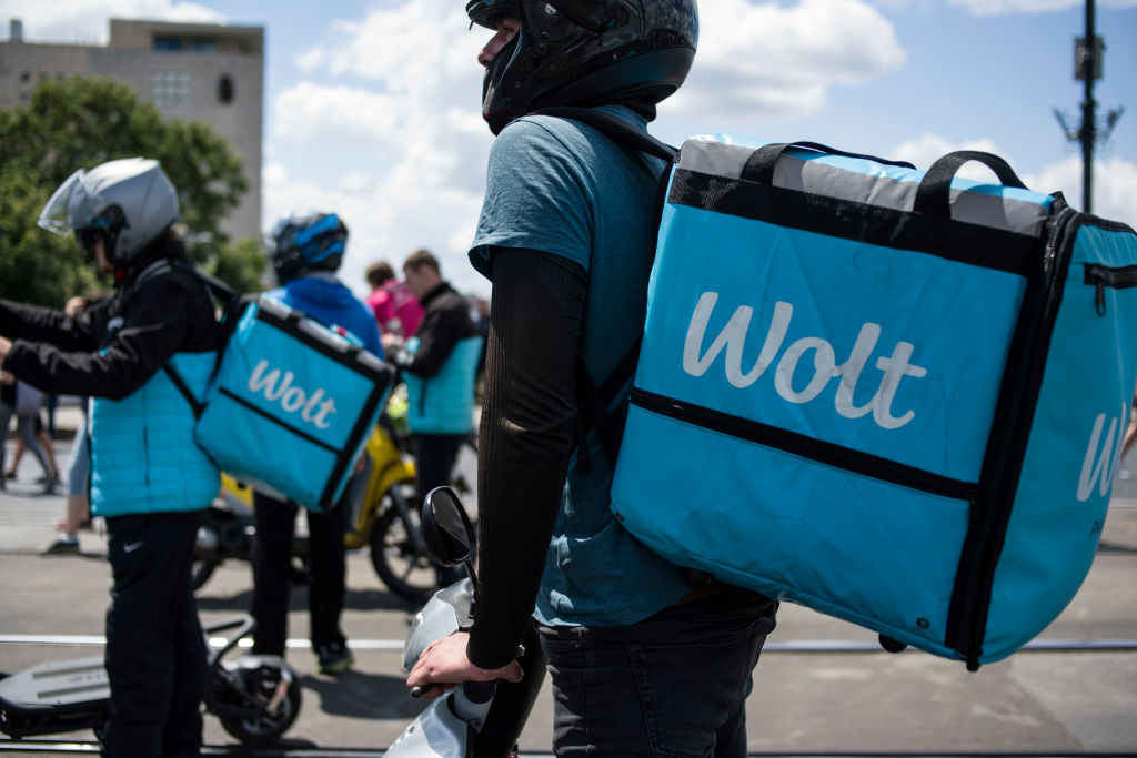 WOLT food deliverers join protesters during the