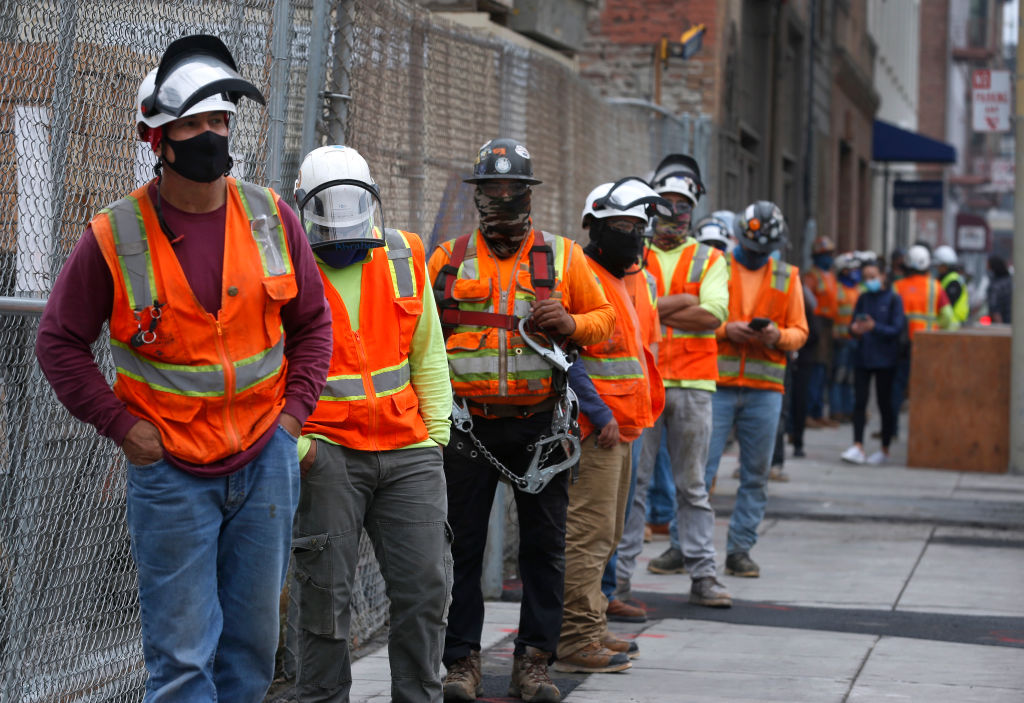 Construction workers wait in line to take a weekly on-site coronavirus test for Build Group employees and workers building a 302-unit residential complex at 434 Minna Street in San Francisco, Calif. on Thursday, Sept. 3, 2020