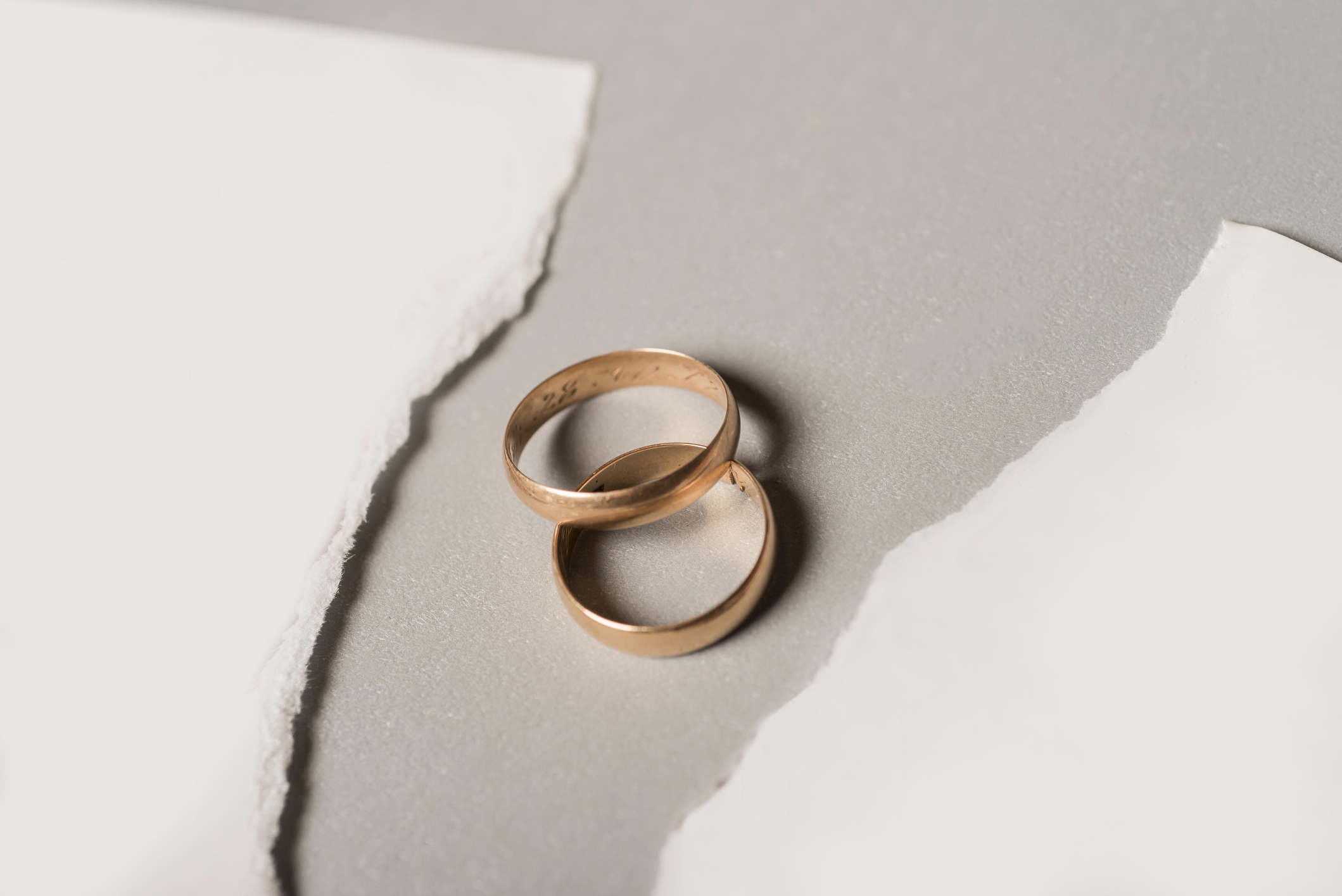 Broken paper with golden wedding rings High quality and resolution beautiful photo concept,Romania