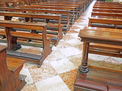 many wooden empty pews in the church