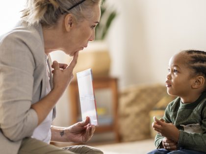 Female speech therapist working with a young preschool boy