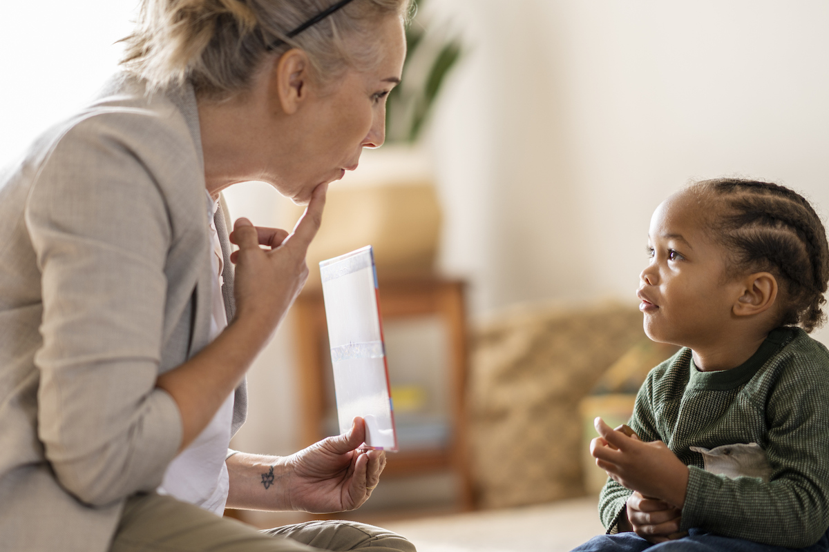 Female speech therapist working with a young preschool boy
