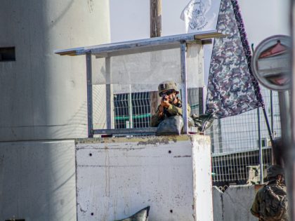 An Israeli soldier stands guard at a military post while