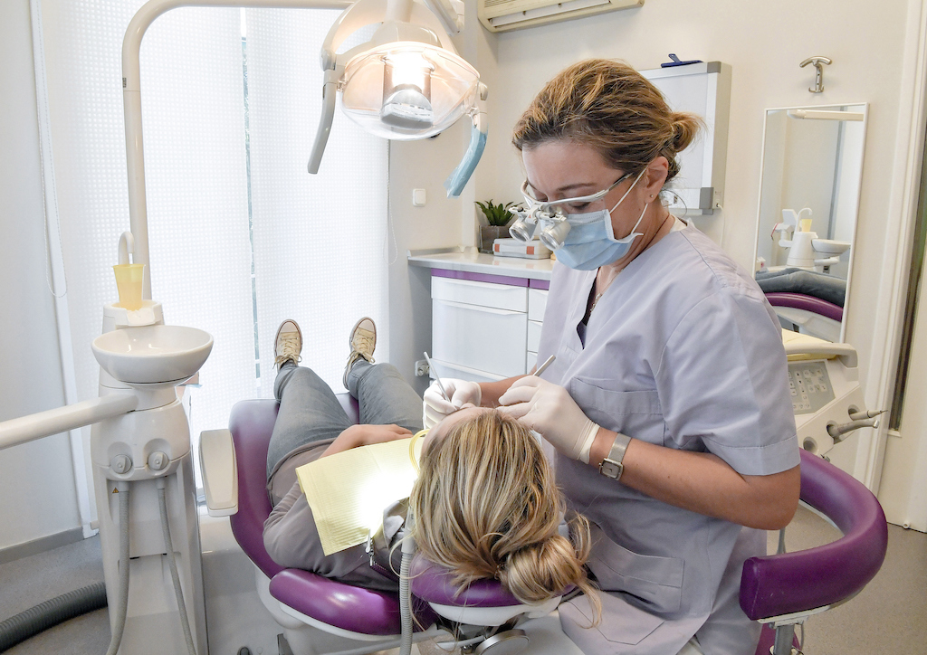 Female dentist examines a patient in a dental clinic