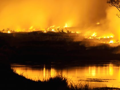 Forest fires, bushfires with flames, and illuminated smoke clouds by Climate Change