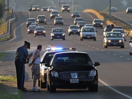 (070510 Medford, MA) A Massachusetts State Police officer performs a traffic stop on I-93 Southbound on Monday, July 5, 2010. Staff Photo by Matthew West.