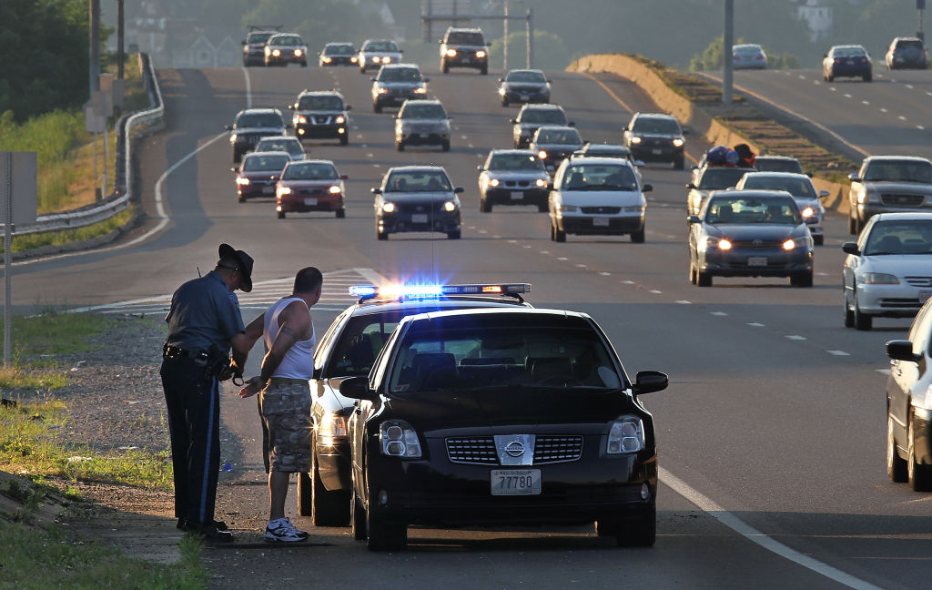 (070510 Medford, MA) A Massachusetts State Police officer performs a traffic stop on I-93 Southbound on Monday, July 5, 2010. Staff Photo by Matthew West.
