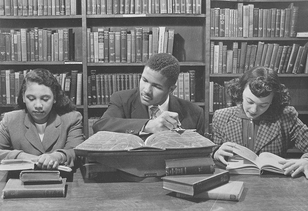 College Students Reading A Book