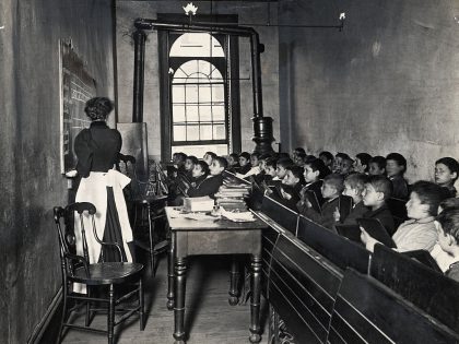 Teacher Instructing Schoolboys in Small Classroom