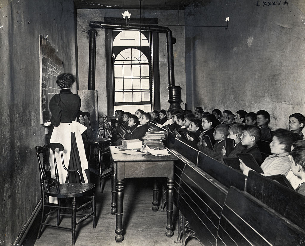 Teacher Instructing Schoolboys in Small Classroom