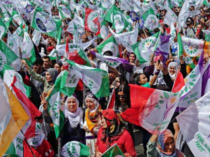 Supporters wave flags during the rally of the Green Left