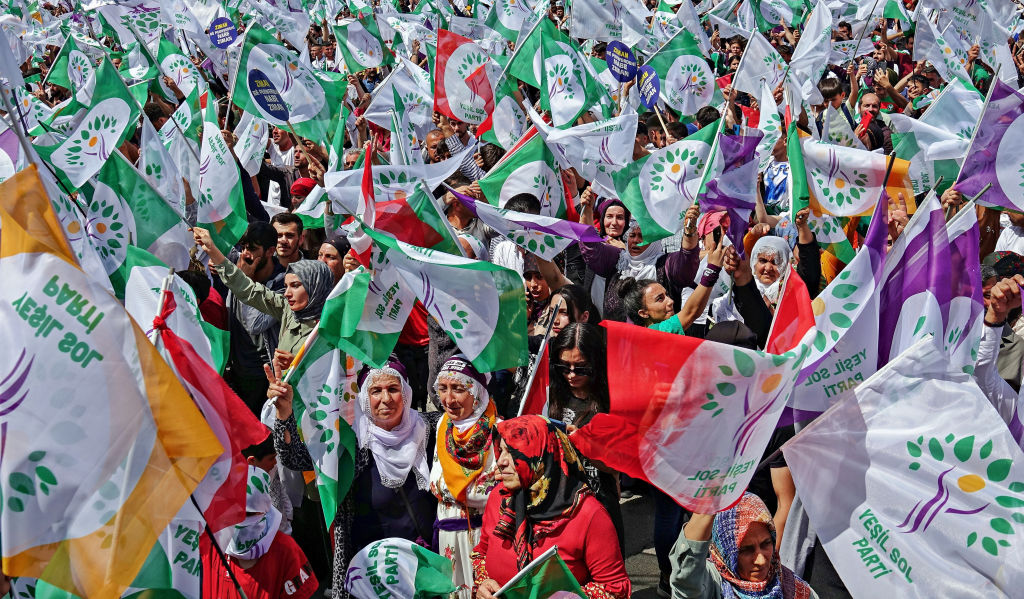 Supporters wave flags during the rally of the Green Left
